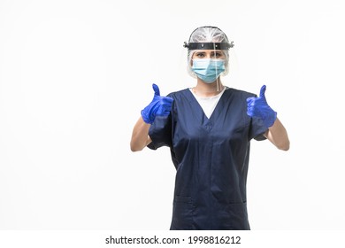 Medicine, Healthcare And Protection Concept. Doctor Woman Nurse In Blue Uniform, Protective Medical Mask And Face Shield Showing Thumbs Up Over White Background