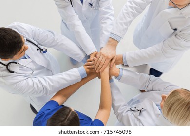 Medicine, Healthcare, Teamwork And People Concept - Group Of Happy Doctors Holding Hands Together At Hospital