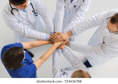 Medicine, Healthcare, Teamwork And People Concept - Group Of Happy Doctors Holding Hands Together At Hospital