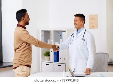 Medicine, Healthcare And Technology Concept - Doctor With And Male Patient Shaking Hands At Hospital