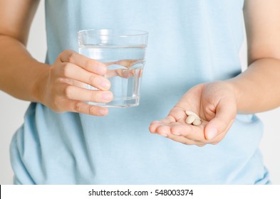 Medicine herb in hand and water,Alternative Medicine,Herbal supplement pill,eating healthy
