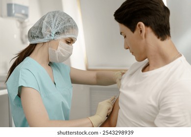 Medicine nurse at medical laboratory room. Hospital female employee injects corona virus vaccine in hand. Indoors shot of biochemistry for therapy covid-19 infection at doctor office with equipment - Powered by Shutterstock