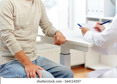 medicine, old age, healthcare and people concept - close up of senior man and doctor meeting in medical office at hospital