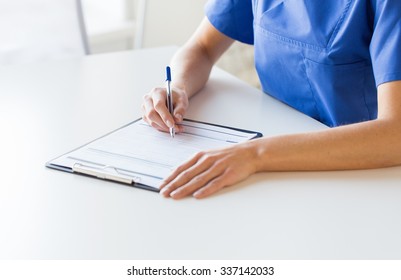 medicine, people and healthcare concept - close up of female doctor or nurse writing medical report to clipboard at hospital - Powered by Shutterstock