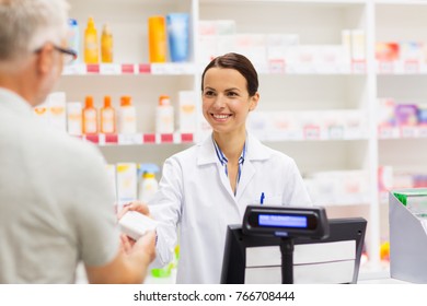medicine, pharmaceutics, health care and people concept - apothecary and senior man customer buying drug at drugstore