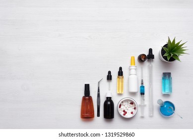 Medicine, pharmacology, pharmacy background. Laboratory table with a various drugs, syringe and jars background with copy space. - Shutterstock ID 1319529860