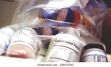 medicine pills bottles, vitamins and supplements in plastic bag close up background concept. - Shutterstock ID 1283723767