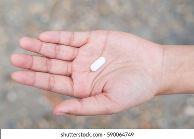 Medicine pills or capsules in hand, Medicine in palm