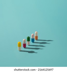 Medicine pills with colorful elements and human shadows on the surface. Health, drugs addiction conceptual background. - Shutterstock ID 2164125697