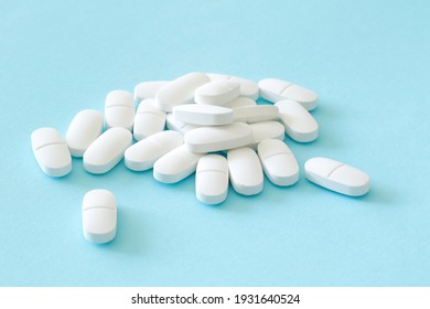 lot of medicine pills on blue background - Shutterstock ID 1931640524