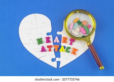 Medicine For Preventing Heart Attacks Concept. White Jigsaw Puzzles Heart, Drugs Under Magnifying Glass And Text Heart Attack.