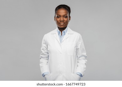 Medicine, Profession And Healthcare Concept - Smiling African American Female Doctor Or Scientist In White Coat Over Grey Background