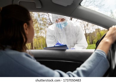 Medicine, Quarantine And Pandemic Concept - Doctor Or Healthcare Worker In Protective Gear Or Hazmat Suit, Medical Mask, Face Shield And Goggles And Woman In Car Waiting For Coronavirus Test