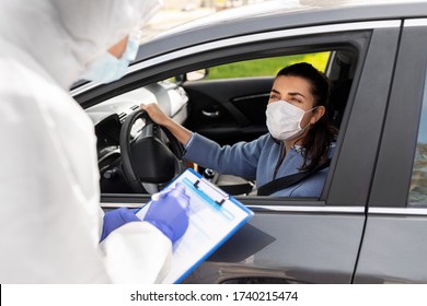 medicine, quarantine and pandemic concept - doctor or healthcare worker in protective gear, medical mask, gloves and goggles with clipboard and woman waiting for coronavirus test in her car
