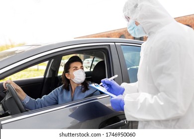 Medicine, Quarantine And Pandemic Concept - Doctor Or Healthcare Worker In Protective Gear, Medical Mask, Gloves And Goggles With Clipboard And Woman Waiting For Coronavirus Test In Her Car