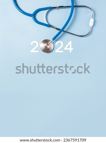 Medicine stethoscope and numbers 2024 on blue background. Happy New Year medical calendar cover. Vertical banner, copy space
