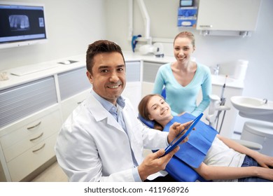 Medicine, Stomatology, Technology And Health Care Concept - Happy Male Dentist With Tablet Pc Computer, Patient Girl And Her Mother At Dental Clinic Office