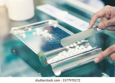 Medicine tablets on counting tray with counting spatula at pharmacy. - Powered by Shutterstock