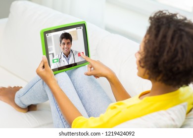 Medicine, Technology And Healthcare Concept - African American Young Woman Or Patient Having Video Chat With Doctor On Tablet Pc Computer At Home