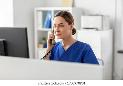 Medicine, Technology And Healthcare Concept - Female Doctor Or Nurse With Computer Calling On Phone At Hospital