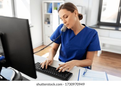 Medicine, Technology And Healthcare Concept - Female Doctor Or Nurse With Computer Calling On Phone At Hospital