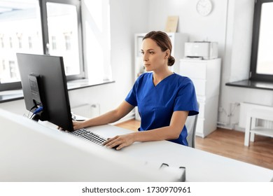 Medicine, Technology And Healthcare Concept - Female Doctor Or Nurse With Computer Working At Hospital