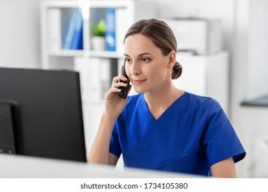 Medicine, Technology And Healthcare Concept - Female Doctor Or Nurse With Computer Calling On Phone At Hospital