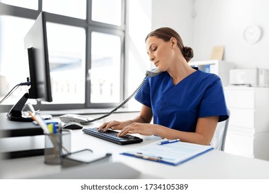 Medicine, Technology And Healthcare Concept - Female Doctor Or Nurse With Computer Calling On Phone At Hospital