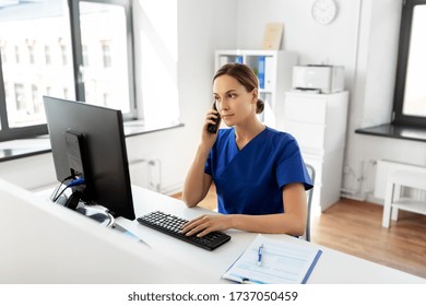 Medicine, Technology And Healthcare Concept - Female Doctor Or Nurse With Computer Calling On Phone At Hospital