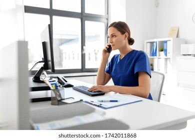 Medicine, Technology And Healthcare Concept - Female Doctor Or Nurse With Computer Calling On Phone At Hospital