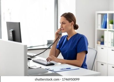 Medicine, Technology And Healthcare Concept - Female Doctor Or Nurse With Computer Calling On Phone At Hospital