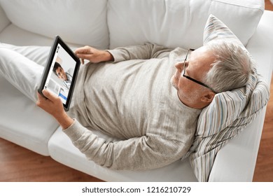 Medicine, Technology And Healthcare Concept - Senior Patient Having Video Chat With Doctor On Tablet Pc Computer At Home