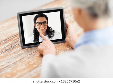 Medicine, Technology And Healthcare Concept - Senior Woman Patient Having Video Call With Doctor On Tablet Pc Computer At Home