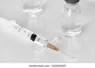 Medicine vials and syringes in the laboratory- Health Beauty and medical concepts- Isolated on white background - Shutterstock ID 2223631027