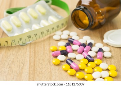 medicines and waist circumference in closeup view with some space on table wood backgrounds
