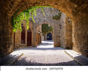 Medieval arched street in the old town of Rhodes, Greece - Powered by Shutterstock