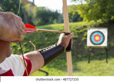 Medieval archer to use a bow and arrow and shoot at a target