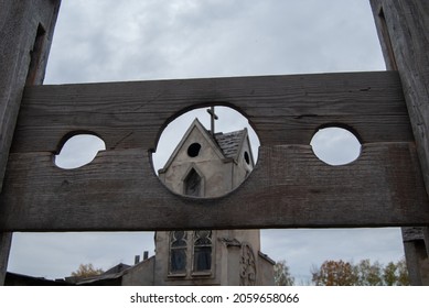 Medieval block for punishing criminals against the background of an ancient church. Medieval execution weapon