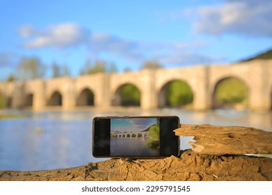 Medieval bridge captured with a camera and a mobile phone at the same time