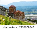 Medieval Byzantine Holy Trinity Church standing on hill in Berat city of Southern Albania on sunny spring day..