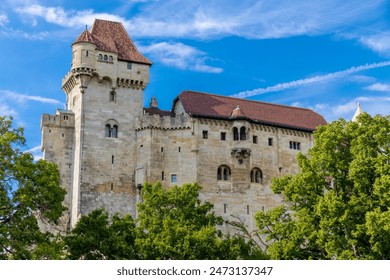 Medieval castle Burg Liechtenstein in Vienna, Austria. Ancient fortress with high stone walls in the middle of green grass meadow - Powered by Shutterstock