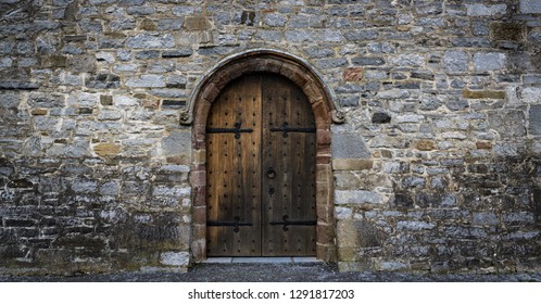 medieval castle wooden door, stone wall panorama