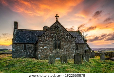 Medieval church on cemetary at dawn. Church cemetary chapel