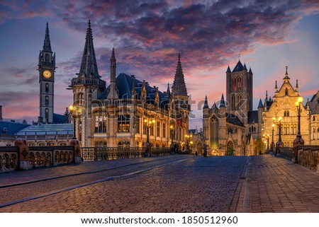 Medieval city of Gent (Ghent) in Flanders with Saint Nicholas Church and Gent Town Hall, Belgium. Sunset cityscape of Gent.