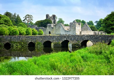 Medieval Desmond Castle, Ireland with old stone bridge, Adare, County Limerick