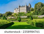 Medieval Dunrobin Castle on a hill and magnificent gardens at the foot of the castle, Scotland, UK.