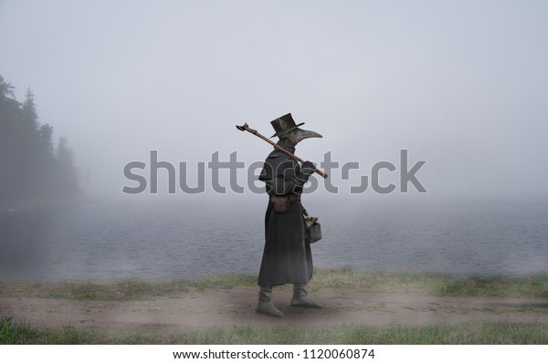Medieval era. The plague doctor walks along the road near the misty lake