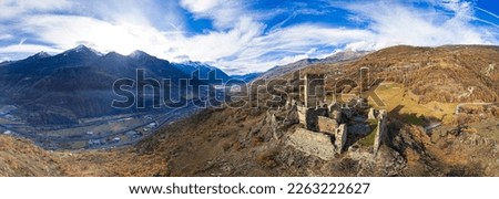 Medieval impressive castle Cly surrouded by Alps mountains in Valle d'aosta, Italy. aerial drone panoramic view