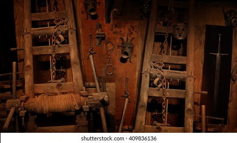 Medieval Inquisition Equipment On The Wall Of Gothic Dungeon.
