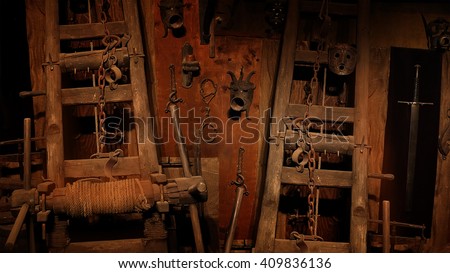 Medieval inquisition equipment on the wall of gothic dungeon.